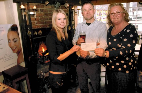 The Horns, Ashbourne.  Cheque presented by Jo-anne Jewett and Lorna Etches to Mike Gerard-Pearse, chairman of Parwich Memorial Hall Management committee.  Reproduced by kind permission of the Ashbourne News Telegraph.  Please click image to enlarge.